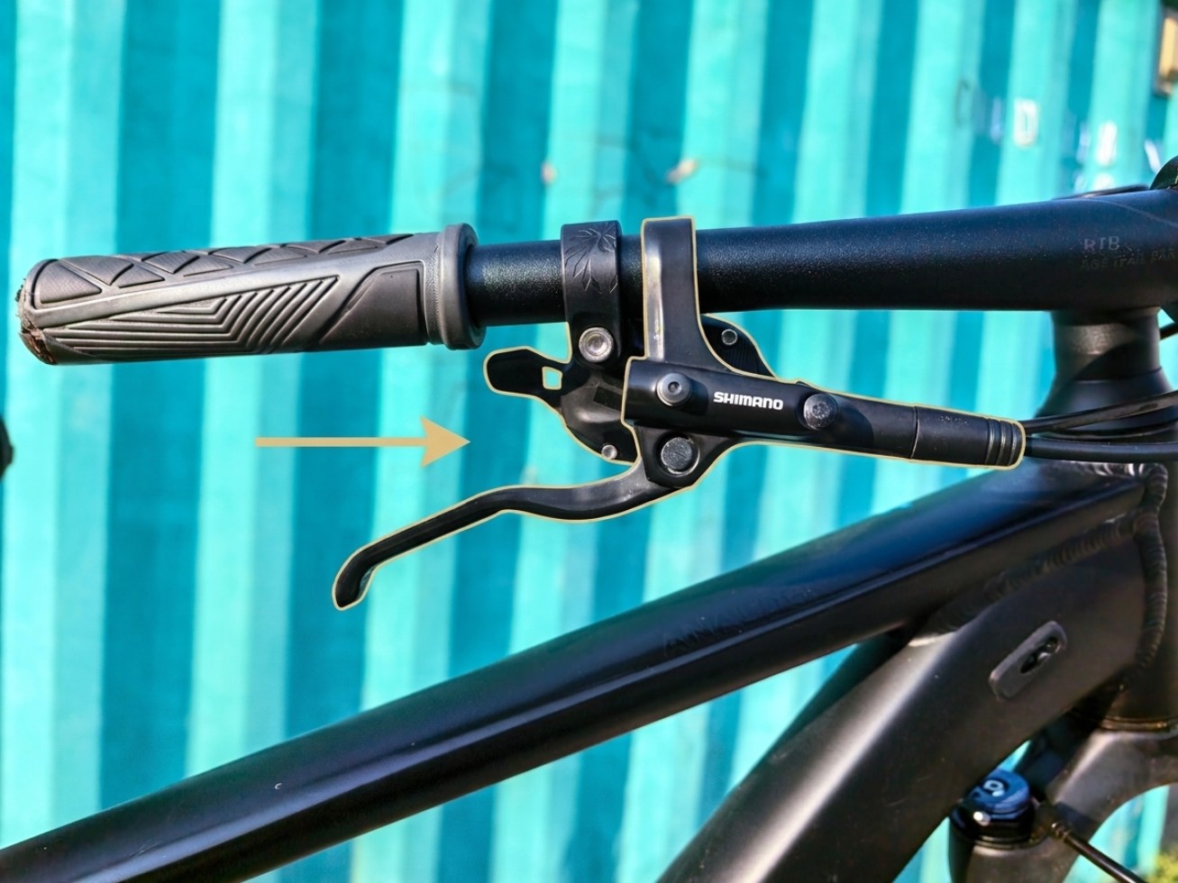Устройство управления велосипедом: тормозная ручка Shimano графически выделена светлым контуром и стрелкой на руле